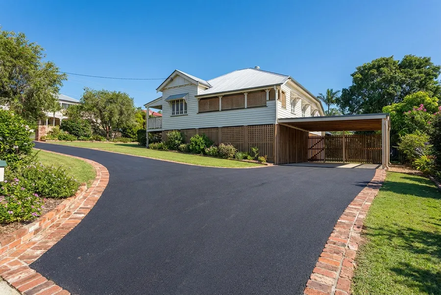 New asphalt driveway with paver border at a highset Queenslander