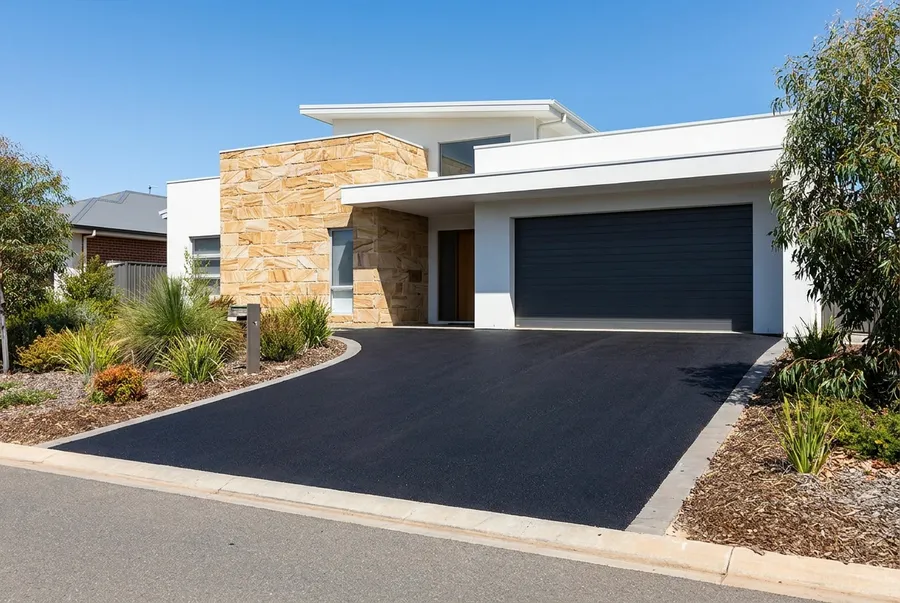 New asphalt driveway at a modern split level home